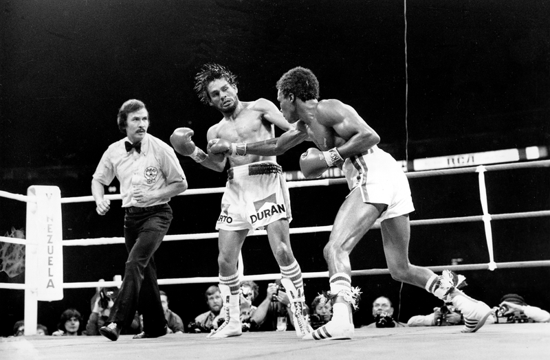 Duran takes a punch from Leonard during their first title fight. Photo credit: AP